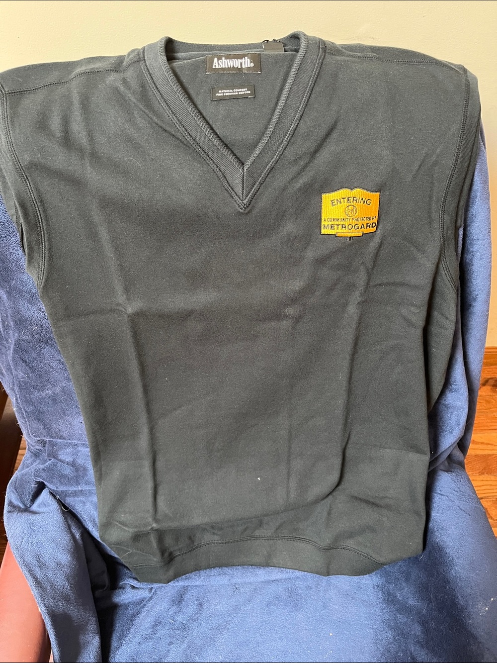 Ashworth Men's V-Neck Sweater Vest in Black with Yellow Patch